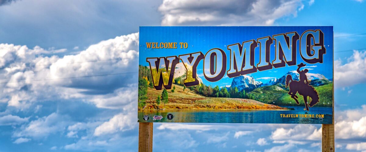 Cheyenne, United States - August 12, 2022:  The iconic "Welcome to Wyoming" sign along the border between Colorado and Wyoming shot on a mid summer afternoon.